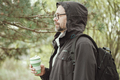 Bearded man  holding reusable silicone mug in hand. Camping, hiking, sustainable consumption. - PhotoDune Item for Sale