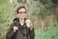 Short-haired woman  holds a reusable silicone mug in hand. Camping, hiking, sustainable consumption. - PhotoDune Item for Sale