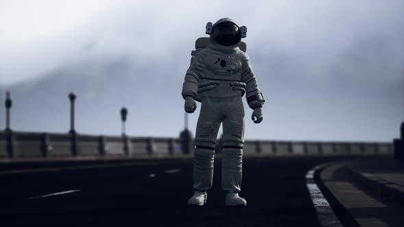 Astronaut Walks in the Middle of a Road