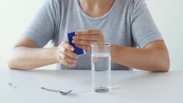 Woman Stirring Medication in Glass of Water 27