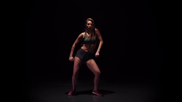 Girl Dancing Hip-hop Movement in Dark Studio. Slow Motion