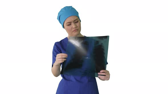 Thinking Female Doctor in Uniform Examining a Chest Xray on White Background