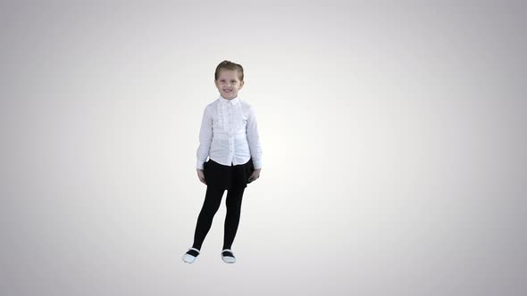 Happy Cute Little Girl Walking in the Frame and Talking To Camera on Gradient Background.