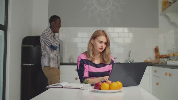 Multiracial Family Working Overtime in Kitchen