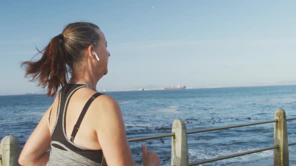 Senior woman running on a promenade