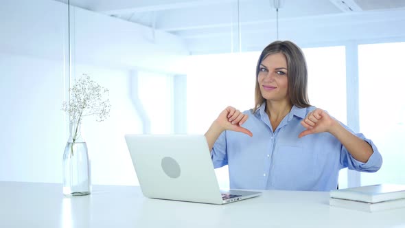 Thumbs Down Gesture by Woman at Her Work