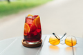 Glass of fresh red sparkling summer cocktail. Glass of Sangria and sunglasses an a table - PhotoDune Item for Sale