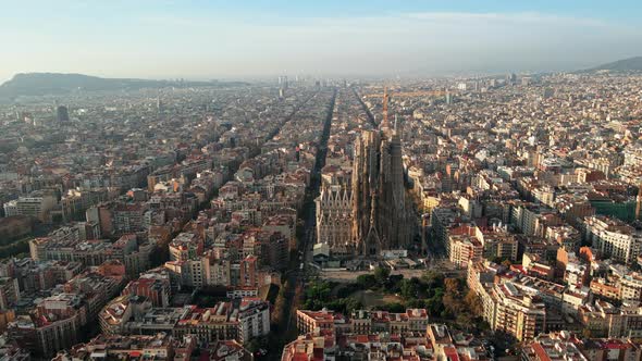 Aerial drone view of Barcelona, Spain. Blocks with multiple residential buildings and Sagrada Famili