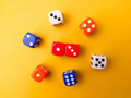 Top view Colored dice on a yellow background. - PhotoDune Item for Sale