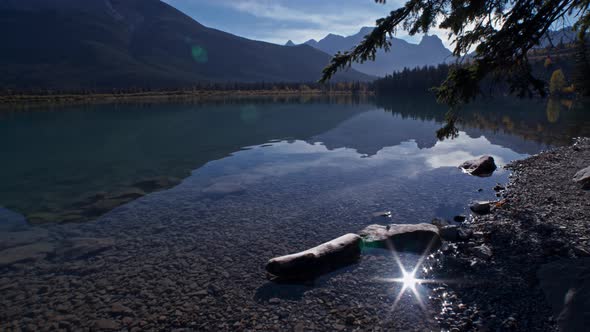 Lake shore with sun flare and reflection