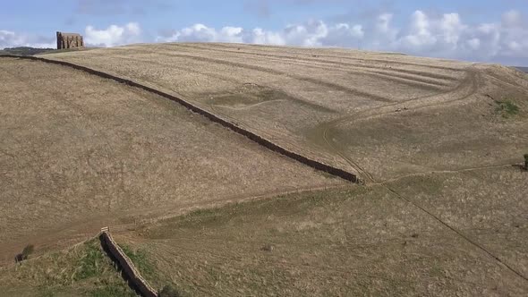 Forward tracking aerial towards the bottom of the hill that St Catherine's Chapel in Dorset sits. Ne