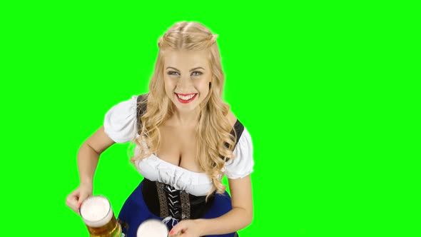 Girl in a Bavarian Costume and Offers Someone for the Glasses with Beer. Green Screen