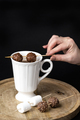 A woman's hand stirs hot chocolate with chocolates skewer - PhotoDune Item for Sale