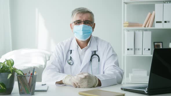 Elderly Grayhaired Doctor in Protective Mask and Gloves Portrait of Male Therapist Wearing Glasses