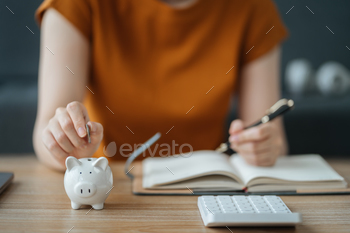 ng expenses, paying bills using laptop online, making household financial analysis, closer focus on the white piggy bank. Save money to future It is the concept of provident fund.