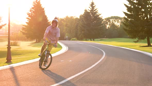 Happy Young Student Cycling Outdoors