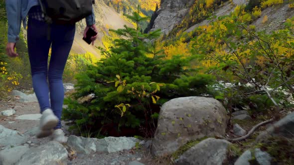 A young beautiful slender woman alone in the mountains.