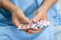 Asian elderly woman patient holding drug in her hand, healthy strong medical concept. - PhotoDune Item for Sale