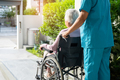 Caregiver help and care Asian senior woman patient sitting on wheelchair to ramp in nursing hospital - PhotoDune Item for Sale