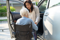 Caregiver help and support asian elderly woman sitting on wheelchair prepare get to her car   - PhotoDune Item for Sale