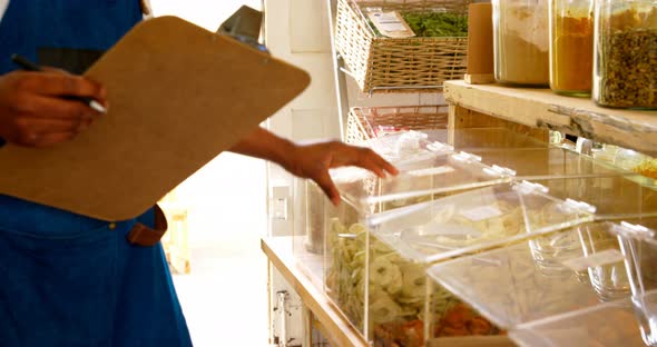 Male staff checking stock in supermarket 4k