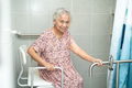 Asian elderly woman patient use toilet bathroom handle security in nursing hospital. - PhotoDune Item for Sale