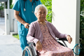 Doctor caregiver help and care Asian elderly woman patient sitting on wheelchair in park at hospital - PhotoDune Item for Sale