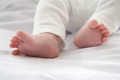 Baby feet on a white blanket close up - PhotoDune Item for Sale