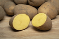 Dutch variety potato called Bintje whole and halved on wooden background - PhotoDune Item for Sale