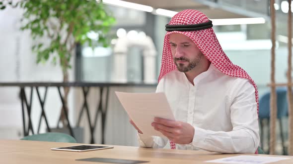 Hardworking Arab Businessman Reading Documents 