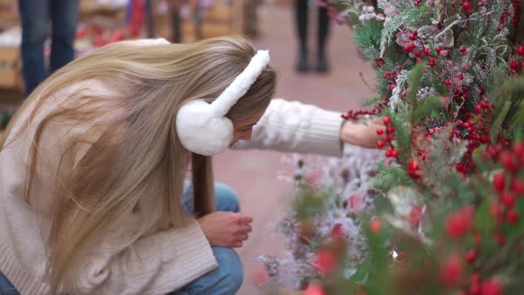 Christmas Shopping European Woman Choose Branches for Christmas Wreath Indoor in Supermarket