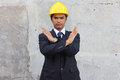 Serious engineer Asian man wearing hardhat cross his arms on his chest showing stop  - PhotoDune Item for Sale