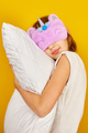 Nice teenage girl in white pyjamas with a violet sleeping mask embraces a pillow - PhotoDune Item for Sale