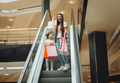 mother and little girl on the escalator in the mall.Mother and daughter in the mall. - PhotoDune Item for Sale