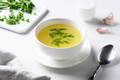 Chicken broth with green onion in white bowl on white table. Copy space. - PhotoDune Item for Sale