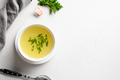 Chicken broth with green onion in white bowl on white table. Copy space. Top view. - PhotoDune Item for Sale