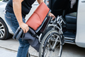 Asian woman folding and lift up wheelchair into her car. Accessibility concept. - PhotoDune Item for Sale