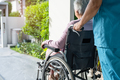 Caregiver help and care Asian senior woman patient sitting in wheelchair on ramp at hospital. - PhotoDune Item for Sale