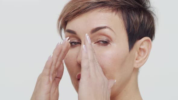 Close-up of middle aged mature woman over white background.