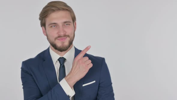 Young Businessman Pointing on Side on White Background