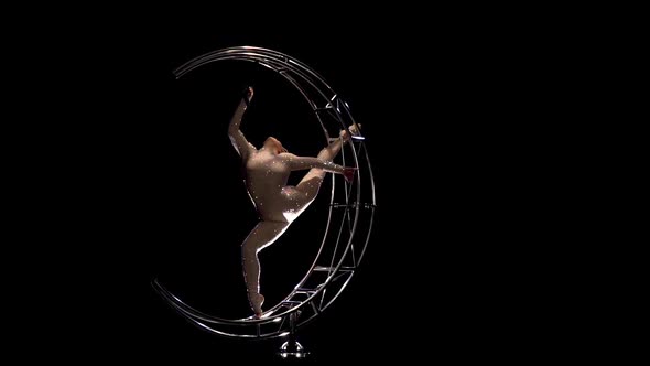 Gymnast a Rotates on a Metal Structure Moon in a Vertical String