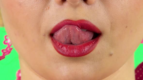 Young Girl Licks Her Lips with Her Tongue. Close Up