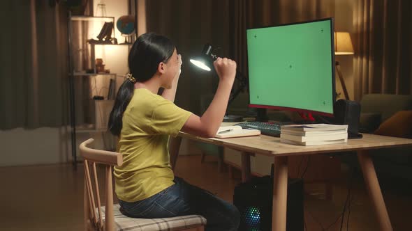 Asian Girl Student Celebrating With Mock Up Computer Green Screen At Home, Learning Online