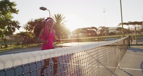 Video of happy african american female tennis player holding racket and hitting ball