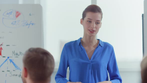 Confident Woman Presenting Startup Office