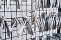 row of various stainless steel dental extraction forceps tools hanging on display - PhotoDune Item for Sale