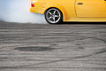 yellow sport car drifting on gray speed tarmac track with smoke coming out of the back  tire wheel - PhotoDune Item for Sale