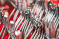 row of various dental extraction forceps tools on display on red background - PhotoDune Item for Sale