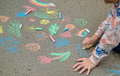 Children draw with chalk on the pavement. Selective focus. - PhotoDune Item for Sale