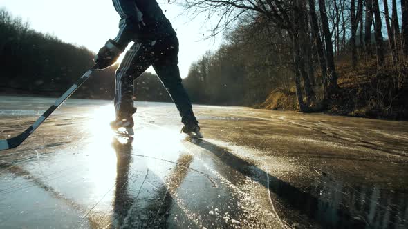 MOSCOW RUSSIA 10 DECEMBER 2019 Hockey Player on Frozen Lake Make Ice Sparkles on High Speed Braking
